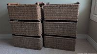 Front and side view of two stacks of three wicker baskets each showing their rectangular shape and wooden handles.