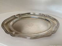 Full view of oval scalloped tray on white surface