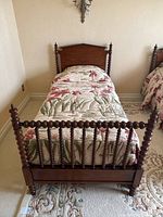 Front view of spool single bed with bedding