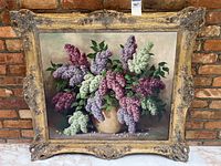 Full front view of framed painting showing lilac bouquet and ornate gold frame