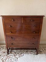 Front view showing six drawers and spindle stretcher base