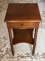 Square walnut tabletop showing grain and finish.