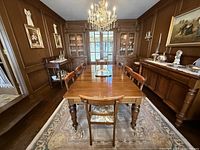 Table fully extended with all four leaves in situ, viewed down center of dining room