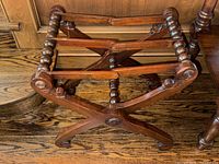 View of the folding butler's tray stand from above and at an angle showing the spindle support design and cross-legged base.