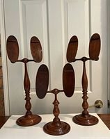 All three walnut display stands side by side, front view