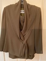Taupe draped-front jacket and matching shell set hung on hanger