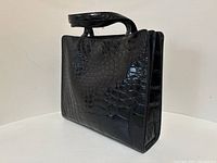 Angled front view showing crocodile texture across side and face