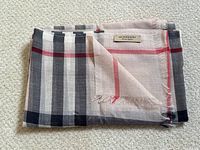 Folded scarf showing Burberry woven label and check pattern