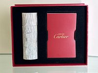 Metal Cartier perfume dispenser in original red Cartier box with foam insert and user booklet.
