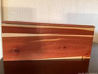 Side view of the cedar storage box showing natural wood grain patterns and smooth finish.