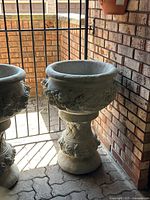 Front view of cement planter bowl mounted on matching pedestal