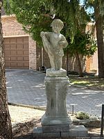 Full front view of cherub figure and pedestal