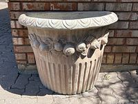 Front view of half-moon planter showing full shape and decorative fruit motif