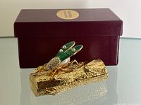 Image of the Edgar Berebi cicada trinket box on a reflective glass surface with original burgundy box background showing whole item and packaging.