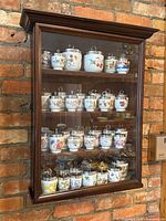 Full front view of wall-mounted cabinet filled with egg coddlers