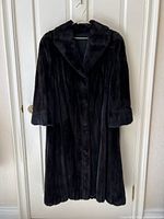 Full view of coat on hanger showing overall length and fit