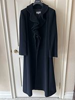 Full-length front view of coat hanging on door