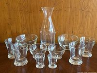Full set displayed showing the decanter, glasses, bowls, and shot glasses in the lot