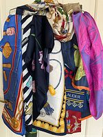 Assorted scarves draped on hanger showing all designs