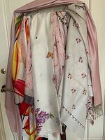 Main display of all six scarves hung on a single hanger showing overall lot composition and color variety