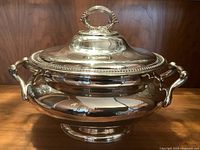 Front view of James Dixon & Sons silver plated soup tureen with lid showing beaded edge and ornate handles on a wooden surface.