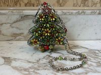 Front view of the tree-shaped purse with chain strap coiled in front