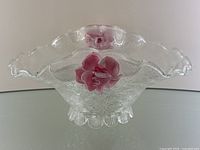 Front view of clear textured Murano glass bowl with silver flakes and pink rose detail on the side.