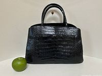 Front view with green apple for scale