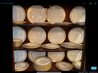 Full set displayed on shelving: multiple stacks of plates and bowls.