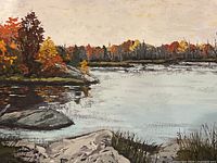 Close-up of painted landscape showing lake, rocky shoreline, autumn trees, and artist signature 'Jean Spinney'