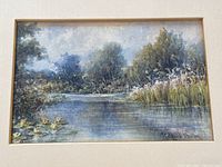 Close-up image of the watercolour painting showing the river landscape with trees, reeds, and ducks, and the artist's signature in lower right corner.