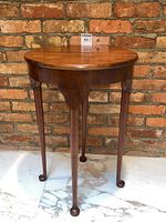 Front view of half-moon table with leaf down