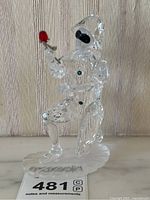 Full view of the Swarovski crystal jester figurine kneeling, showing the entire figure and its intricate details including the red rose it holds.