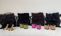 Overview of all three pairs of interchangeable Tanya Heath replacement heels displayed with their protective fabric pouches.