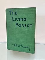 Front cover showing green cloth, title in blue, and author’s signature