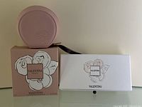 Set items shown with perfume pouch and two boxed bath soaps