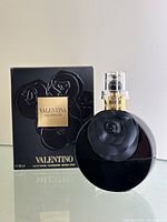 Front view of bottle displayed alongside original box