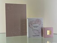 Valentina leather notebook (pink with floral emboss) alongside Valentina Eau De Parfum 50ml box and Valentino Donna solid perfume box.