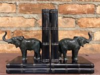 Front view of both bookends showing elephants on stacked books