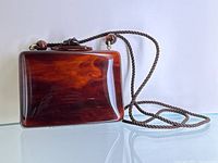 Front view showing marbled tortoiseshell body and rope strap