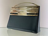 Front view of satchel showing gold-tone metal bar design and smooth green leather