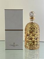 Front view of sealed perfume bottle and box side by side