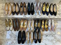 Overall shot showing two rows of various women’s size 11 designer shoes