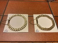 Two vintage Luxor heavy gold tone link bracelets on branded cards showing overall appearance and packaging.