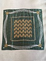 Full view of green silk scarf showing overall pattern and condition
