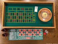 Full view of the oak roulette game board with betting layout, roulette wheel, chip holders, betting board, and dice box