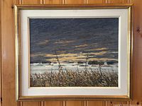 Full view of framed painting against wood wall