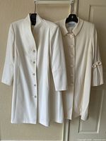 Both jackets hung side by side showing overall silhouettes and colors.