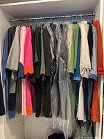 Overview of multiple wool sheath dresses hanging on rail