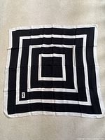 Full view of square scarf laid flat